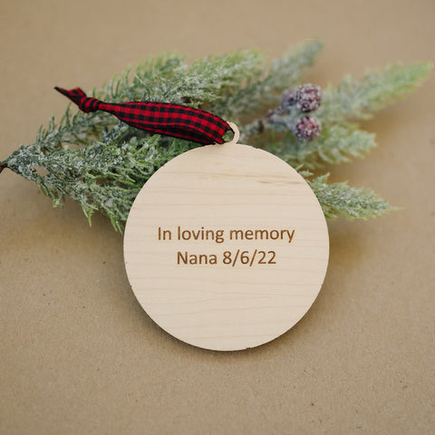 Officially licensed Christmas in Heaven memorial wooden ornament by John F Connor, featuring a poignant chair design with the iconic 'Christmas in Heaven' poem. A heartfelt remembrance gift for the holiday season, this maple and walnut ornament can be personalized on the back with any name or phrase. Versatile for use as a tree ornament or a year-round display, it serves as a touching sympathy gift, preserving cherished memories with enduring grace.