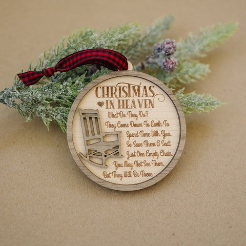 Officially licensed Christmas in Heaven memorial wooden ornament by John F Connor, featuring a poignant chair design with the iconic 'Christmas in Heaven' poem. A heartfelt remembrance gift for the holiday season, this maple and walnut ornament can be personalized on the back with any name or phrase. Versatile for use as a tree ornament or a year-round display, it serves as a touching sympathy gift, preserving cherished memories with enduring grace.