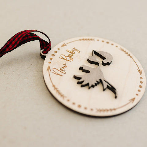 Embrace the joy of Baby's First Christmas with our delightful Stork Ornament. This charming keepsake, intricately designed, is the perfect addition to commemorate this special milestone.