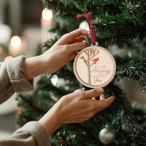 Cardinal memorial wooden ornament, adorned with the heartfelt phrase 'I am always with you,' creating a touching tribute to celebrate everlasting love and cherished memories. The ornament can be personalized on the back with any name or phrase.