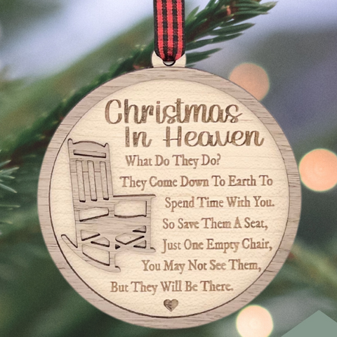 Officially licensed Christmas in Heaven memorial wooden ornament by John F Connor, featuring a poignant chair design with the iconic 'Christmas in Heaven' poem. A heartfelt remembrance gift for the holiday season, this maple and walnut ornament can be personalized on the back with any name or phrase. Versatile for use as a tree ornament or a year-round display, it serves as a touching sympathy gift, preserving cherished memories with enduring grace.