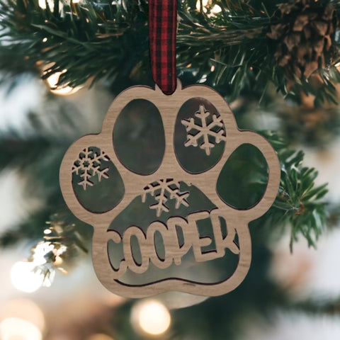 Capture your furry friend's spirit with the Dog Paw Print Personalized Ornament. Add a custom touch by imprinting your dog's name, creating a heartfelt keepsake for your holiday celebrations.