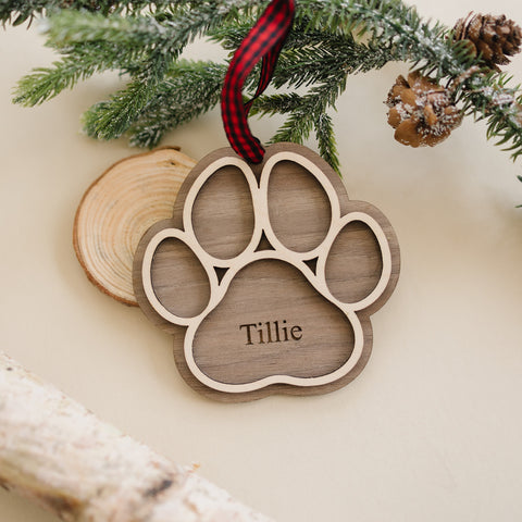 Adorable Personalized Dog Paw Ornament - Cherish your furry friend with this customized ornament featuring a cute paw print. Add your dog's name for a truly special keepsake, perfect for celebrating the joy your pet brings to your holiday season.