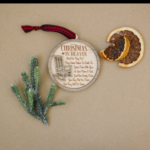 Officially licensed Christmas in Heaven memorial wooden ornament by John F Connor, featuring a poignant chair design with the iconic 'Christmas in Heaven' poem. A heartfelt remembrance gift for the holiday season, this maple and walnut ornament can be personalized on the back with any name or phrase. Versatile for use as a tree ornament or a year-round display, it serves as a touching sympathy gift, preserving cherished memories with enduring grace.