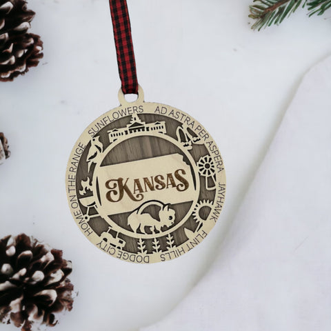 Bring the beauty of the Sunflower State to your holiday tree! Our Kansas State Highlights Ornament captures the essence of the heartland. Elevate your festive decor with the charm of wheat fields and iconic landmarks.