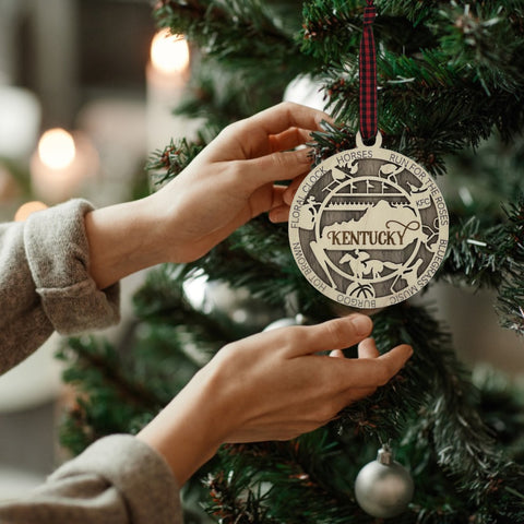 Deck the halls with Bluegrass brilliance! Introducing our Kentucky State Highlights Ornament, a festive tribute to the beauty of the Bluegrass State. From rolling hills to iconic landmarks, add a touch of Kentucky charm to your holiday decor!