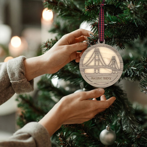 Iconic Mackinac Bridge ornament, featuring the breathtaking steel spans connecting Michigan's Upper and Lower Peninsulas. A majestic addition to your holiday decor, capturing the spirit of this engineering marvel and the beauty of the Great Lakes region.