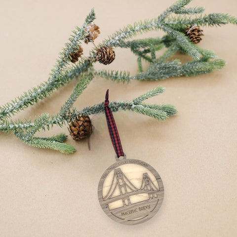 Iconic Mackinac Bridge ornament, featuring the breathtaking steel spans connecting Michigan's Upper and Lower Peninsulas. A majestic addition to your holiday decor, capturing the spirit of this engineering marvel and the beauty of the Great Lakes region.