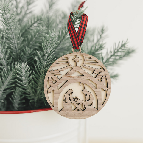 Handcrafted wooden nativity scene ornament depicting the holy family in a serene manger setting, capturing the timeless beauty of the Christmas story.