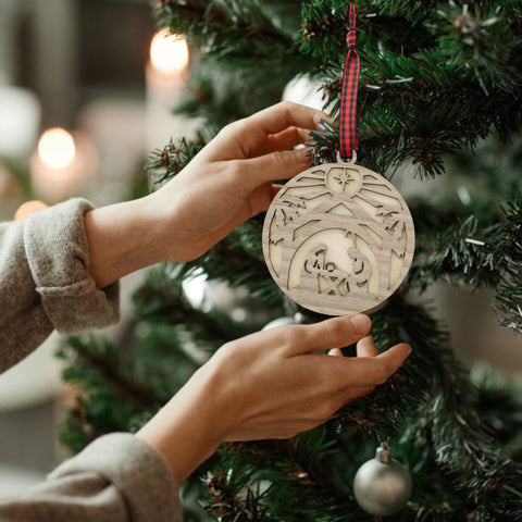 Handcrafted wooden nativity scene ornament depicting the holy family in a serene manger setting, capturing the timeless beauty of the Christmas story.