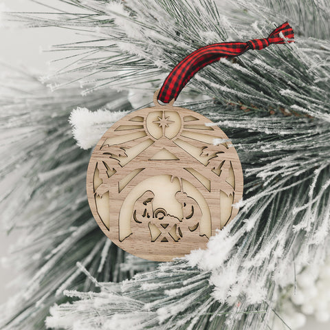 Handcrafted wooden nativity scene ornament depicting the holy family in a serene manger setting, capturing the timeless beauty of the Christmas story.