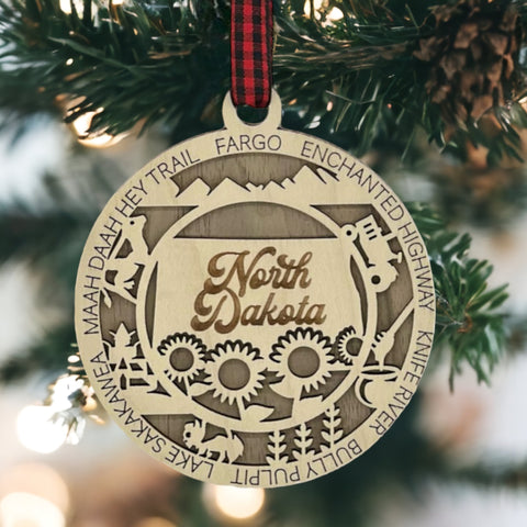 Discover the charm of the Peace Garden State! Introducing the North Dakota State Highlights Ornament—a petite masterpiece capturing the beauty of the Midwest. Elevate your holiday decor with a touch of North Dakota magic.