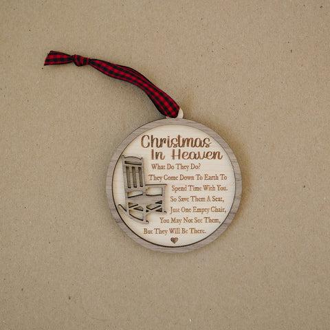 Officially licensed Christmas in Heaven memorial wooden ornament by John F Connor, featuring a poignant chair design with the iconic 'Christmas in Heaven' poem. A heartfelt remembrance gift for the holiday season, this maple and walnut ornament can be personalized on the back with any name or phrase. Versatile for use as a tree ornament or a year-round display, it serves as a touching sympathy gift, preserving cherished memories with enduring grace.