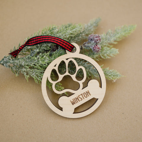 Capture the pawfect moments with our Personalized Dog Paw Bone Ornament. Add a unique touch to your holiday decor by customizing this charming keepsake with your furry friend's name. Celebrate the joy and love your dog brings to your life with this delightful ornament, a heartwarming addition to your festive traditions.