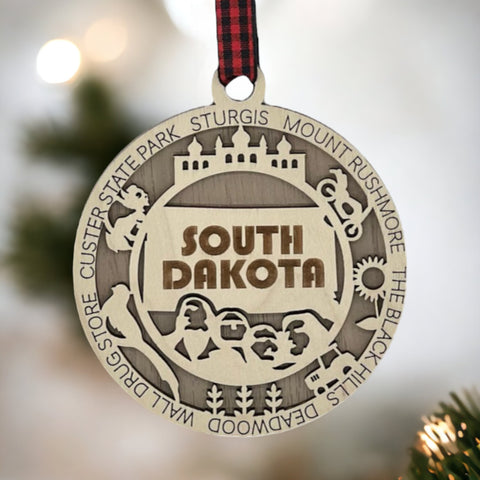 Bring the beauty of the Black Hills to your tree! Introducing the South Dakota State Highlights Ornament—a small treasure celebrating the spirit of the Mount Rushmore State. Elevate your holiday decor with a touch of South Dakota's natural wonders. Make your season merrier with a piece of the Midwest!