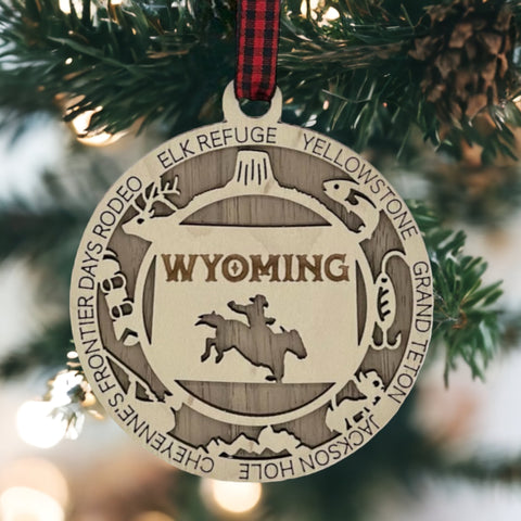 Unwrap the spirit of the Wild West!  Introducing the Wyoming State Highlights Ornament – a miniature masterpiece capturing the rugged beauty and untamed charm of the Cowboy State. Saddle up your holiday decor with a touch of Wyoming wanderlust!