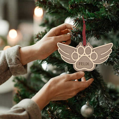 Pay tribute to your beloved feline friend with this personalized cat paw memorial ornament. Add your cat's name for a touching keepsake, celebrating their enduring spirit during the holiday season.