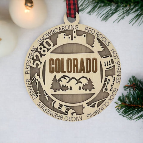 Colorado State Highlights Ornament: A festive decoration showcasing the iconic landmarks, vibrant landscapes, and unique charm of Colorado, including majestic mountains, picturesque forests, and cultural symbols, perfect for celebrating the beauty of the Centennial State during the holiday season.