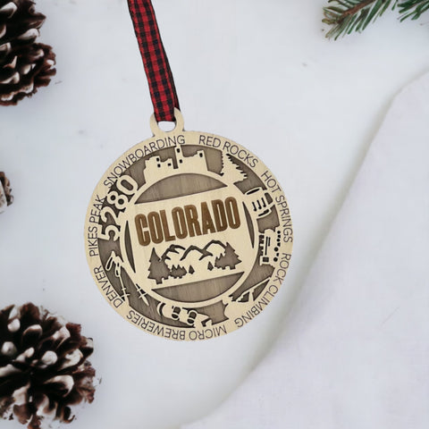 Colorado State Highlights Ornament: A festive decoration showcasing the iconic landmarks, vibrant landscapes, and unique charm of Colorado, including majestic mountains, picturesque forests, and cultural symbols, perfect for celebrating the beauty of the Centennial State during the holiday season.