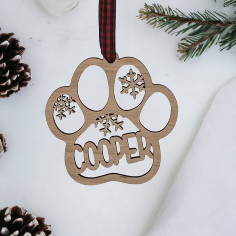 Capture your furry friend's spirit with the Dog Paw Print Personalized Ornament. Add a custom touch by imprinting your dog's name, creating a heartfelt keepsake for your holiday celebrations