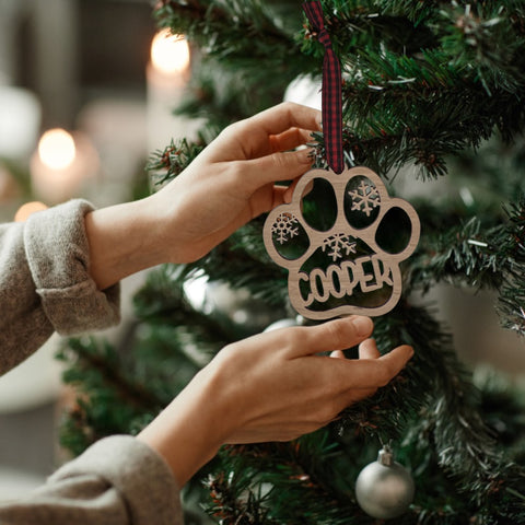 Capture your furry friend's spirit with the Dog Paw Print Personalized Ornament. Add a custom touch by imprinting your dog's name, creating a heartfelt keepsake for your holiday celebrations