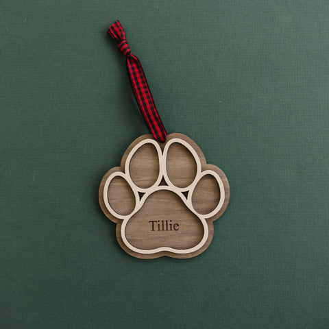 Adorable Personalized Dog Paw Ornament - Cherish your furry friend with this customized ornament featuring a cute paw print. Add your dog's name for a truly special keepsake, perfect for celebrating the joy your pet brings to your holiday season.