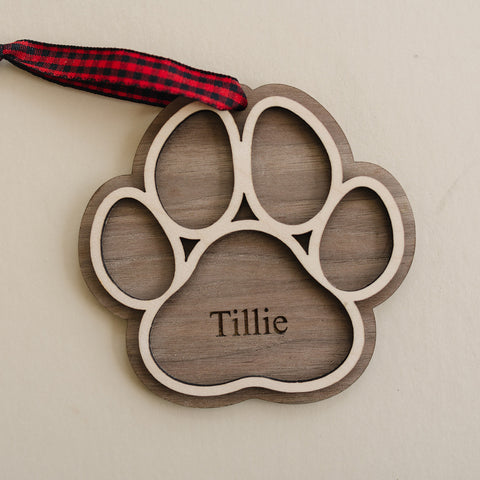 Adorable Personalized Dog Paw Ornament - Cherish your furry friend with this customized ornament featuring a cute paw print. Add your dog's name for a truly special keepsake, perfect for celebrating the joy your pet brings to your holiday season.