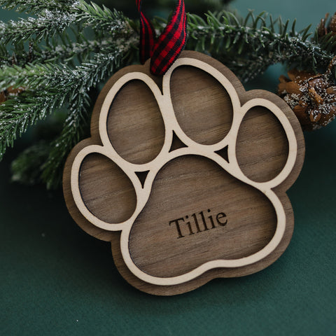 Adorable Personalized Dog Paw Ornament - Cherish your furry friend with this customized ornament featuring a cute paw print. Add your dog's name for a truly special keepsake, perfect for celebrating the joy your pet brings to your holiday season.