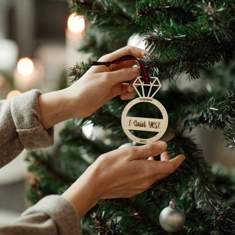 I Said Yes Engaged Ornament - Commemorate the joyous occasion with this charming ornament, symbolizing the beginning of a beautiful journey together. Adorn your tree with this special keepsake, celebrating the excitement of your engagement during the holiday season.