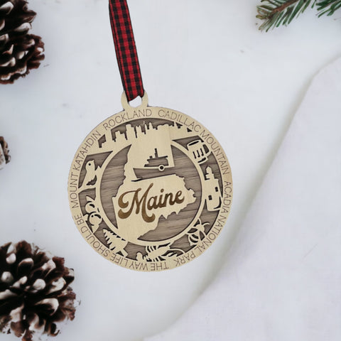 Elevate your holiday with a touch of Maine magic! Introducing our Maine State Highlights Ornament, a coastal-inspired masterpiece. From lighthouses to pine-covered landscapes, celebrate the beauty of the Pine Tree State in every detail. 