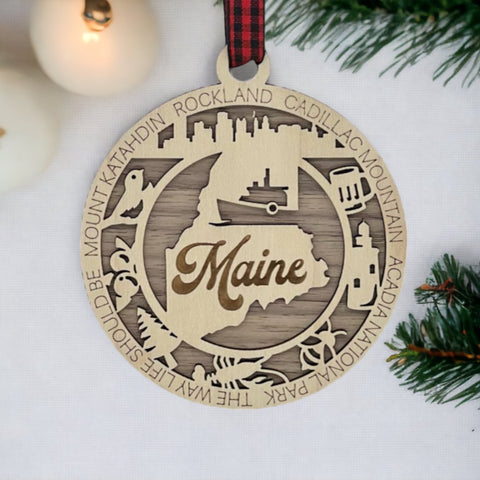 Elevate your holiday with a touch of Maine magic! Introducing our Maine State Highlights Ornament, a coastal-inspired masterpiece. From lighthouses to pine-covered landscapes, celebrate the beauty of the Pine Tree State in every detail. 