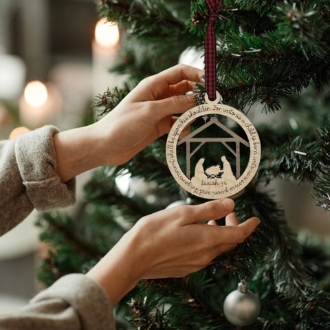 Handcrafted wooden nativity scene ornament depicting the holy family in a serene manger setting, capturing the timeless beauty of the Christmas story.