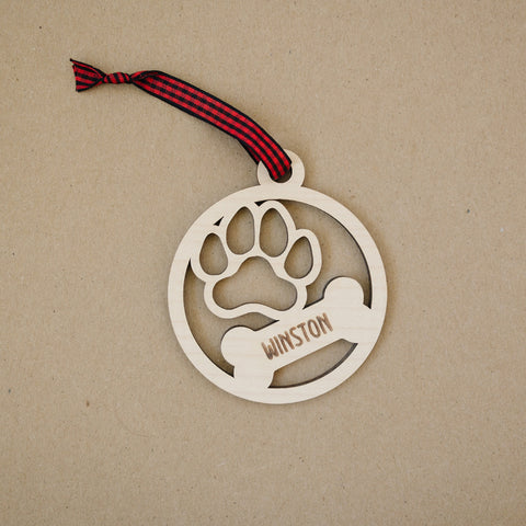 Capture the pawfect moments with our Personalized Dog Paw Bone Ornament. Add a unique touch to your holiday decor by customizing this charming keepsake with your furry friend's name. Celebrate the joy and love your dog brings to your life with this delightful ornament, a heartwarming addition to your festive traditions.