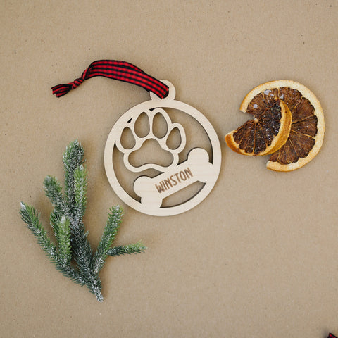 Capture the pawfect moments with our Personalized Dog Paw Bone Ornament. Add a unique touch to your holiday decor by customizing this charming keepsake with your furry friend's name. Celebrate the joy and love your dog brings to your life with this delightful ornament, a heartwarming addition to your festive traditions.