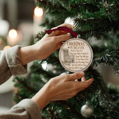 Officially licensed Christmas in Heaven memorial wooden ornament by John F Connor, featuring a poignant chair design with the iconic 'Christmas in Heaven' poem. A heartfelt remembrance gift for the holiday season, this maple and walnut ornament can be personalized on the back with any name or phrase. Versatile for use as a tree ornament or a year-round display, it serves as a touching sympathy gift, preserving cherished memories with enduring grace. 