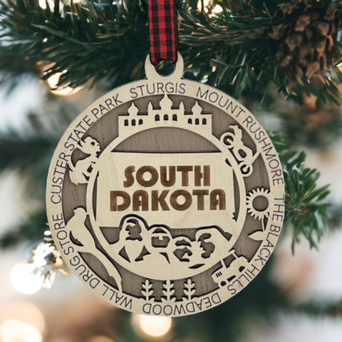 Bring the beauty of the Black Hills to your tree! Introducing the South Dakota State Highlights Ornament—a small treasure celebrating the spirit of the Mount Rushmore State. Elevate your holiday decor with a touch of South Dakota's natural wonders. Make your season merrier with a piece of the Midwest!