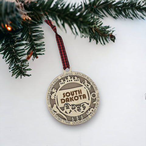 Bring the beauty of the Black Hills to your tree! Introducing the South Dakota State Highlights Ornament—a small treasure celebrating the spirit of the Mount Rushmore State. Elevate your holiday decor with a touch of South Dakota's natural wonders. Make your season merrier with a piece of the Midwest!