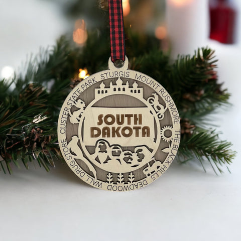 Bring the beauty of the Black Hills to your tree! Introducing the South Dakota State Highlights Ornament—a small treasure celebrating the spirit of the Mount Rushmore State. Elevate your holiday decor with a touch of South Dakota's natural wonders. Make your season merrier with a piece of the Midwest!