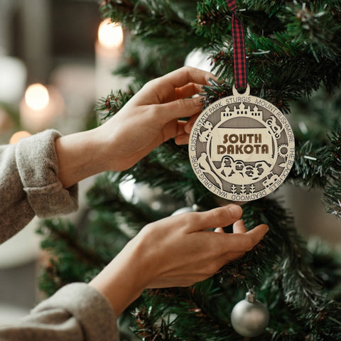 Bring the beauty of the Black Hills to your tree! Introducing the South Dakota State Highlights Ornament—a small treasure celebrating the spirit of the Mount Rushmore State. Elevate your holiday decor with a touch of South Dakota's natural wonders. Make your season merrier with a piece of the Midwest!