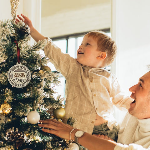 Bring the beauty of the Black Hills to your tree! Introducing the South Dakota State Highlights Ornament—a small treasure celebrating the spirit of the Mount Rushmore State. Elevate your holiday decor with a touch of South Dakota's natural wonders. Make your season merrier with a piece of the Midwest!