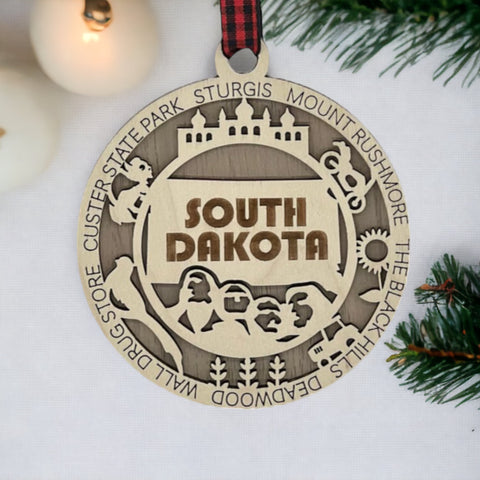 Bring the beauty of the Black Hills to your tree! Introducing the South Dakota State Highlights Ornament—a small treasure celebrating the spirit of the Mount Rushmore State. Elevate your holiday decor with a touch of South Dakota's natural wonders. Make your season merrier with a piece of the Midwest!