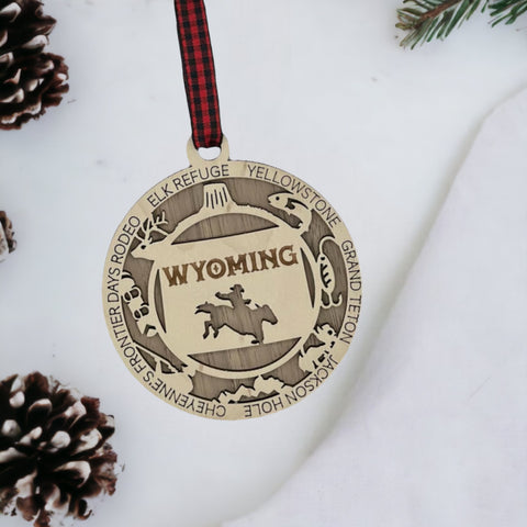 Unwrap the spirit of the Wild West!  Introducing the Wyoming State Highlights Ornament – a miniature masterpiece capturing the rugged beauty and untamed charm of the Cowboy State. Saddle up your holiday decor with a touch of Wyoming wanderlust!