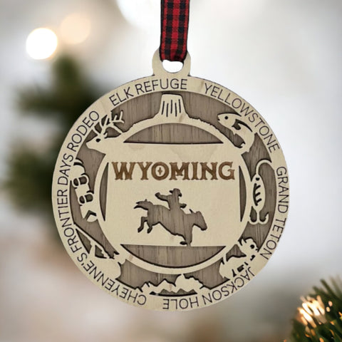 Unwrap the spirit of the Wild West!  Introducing the Wyoming State Highlights Ornament – a miniature masterpiece capturing the rugged beauty and untamed charm of the Cowboy State. Saddle up your holiday decor with a touch of Wyoming wanderlust!