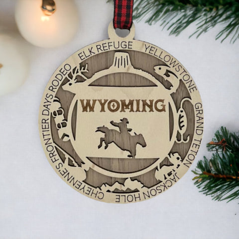 Unwrap the spirit of the Wild West!  Introducing the Wyoming State Highlights Ornament – a miniature masterpiece capturing the rugged beauty and untamed charm of the Cowboy State. Saddle up your holiday decor with a touch of Wyoming wanderlust!