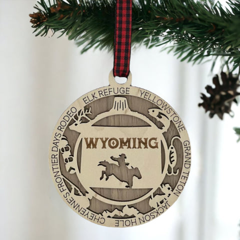 Unwrap the spirit of the Wild West!  Introducing the Wyoming State Highlights Ornament – a miniature masterpiece capturing the rugged beauty and untamed charm of the Cowboy State. Saddle up your holiday decor with a touch of Wyoming wanderlust!